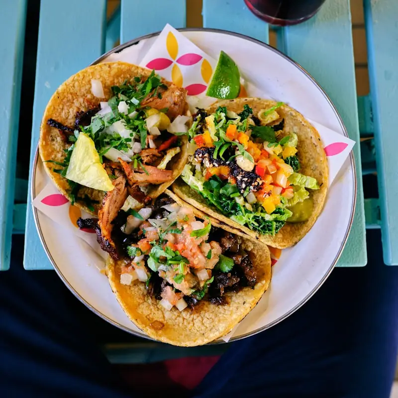 Plate of tacos with fresh garnishes